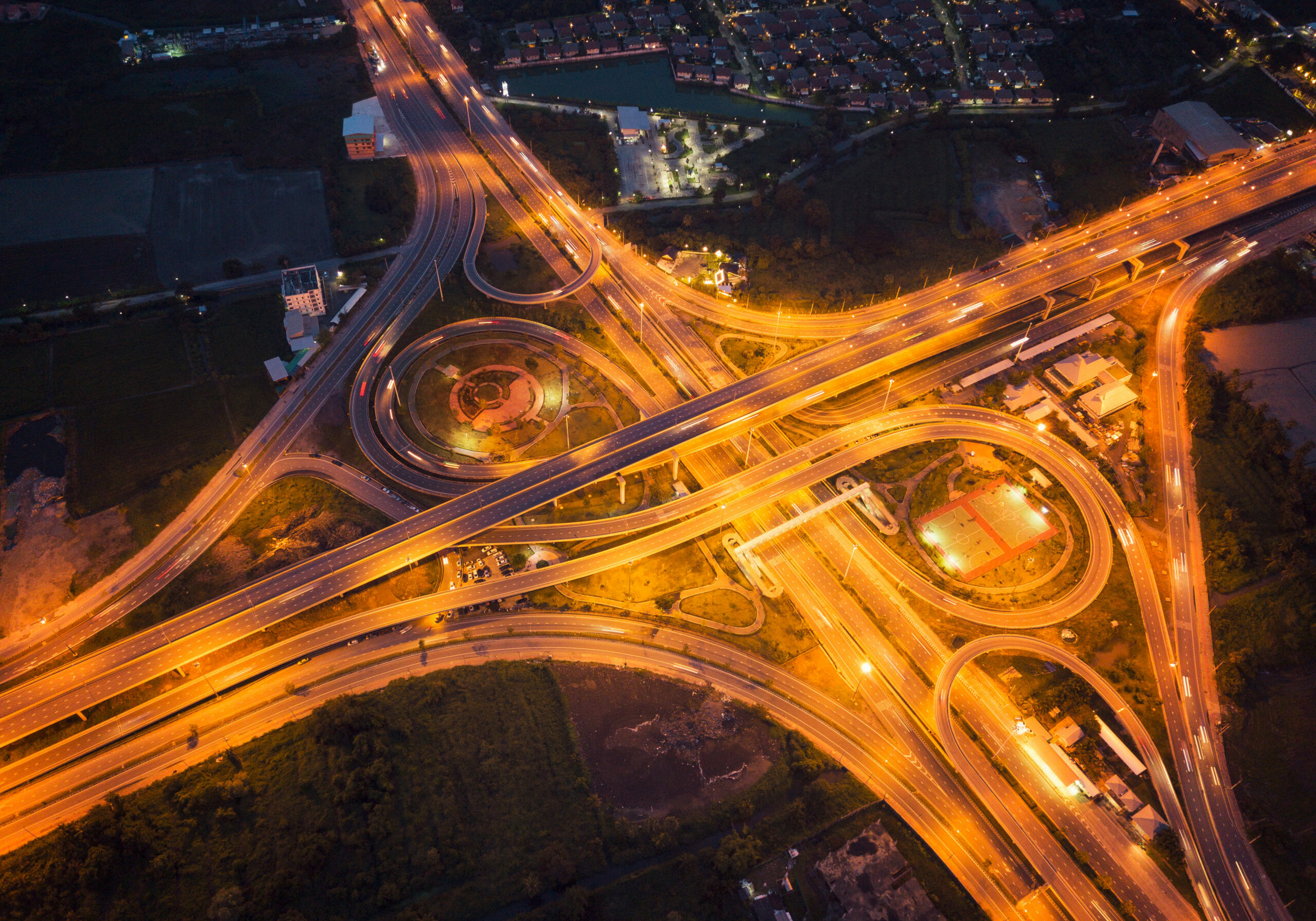 Aerial view of highway junctions. Bridge roads shape number 8 or infinity sign in structure of architecture concept. Top view. Urban city, Bangkok at night, Thailand.