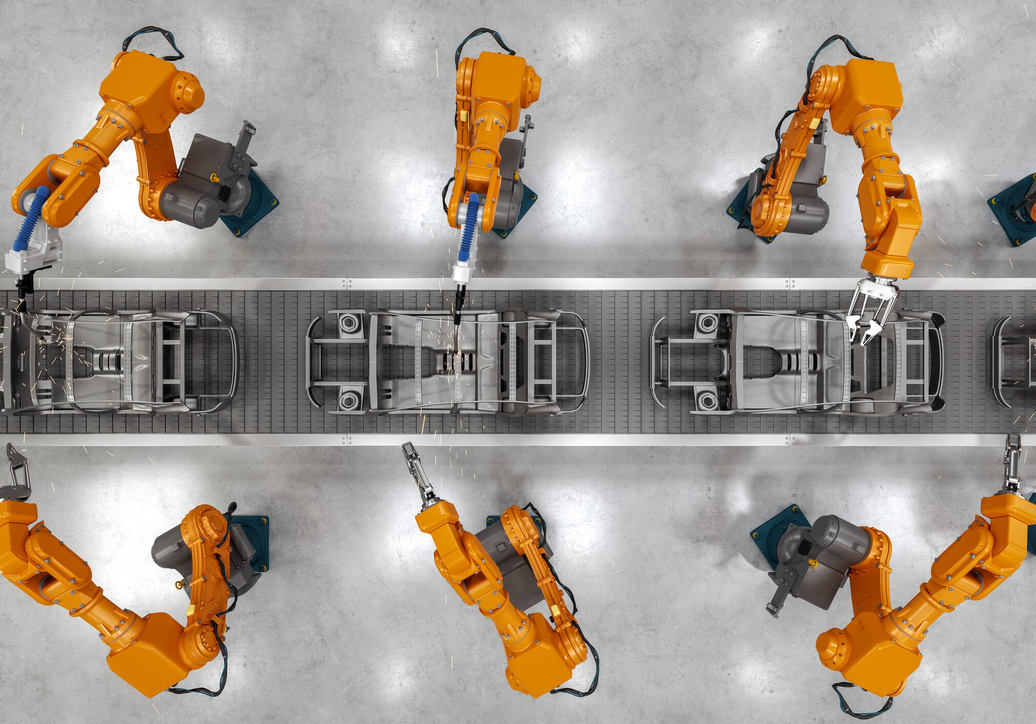 Top view of industrial welding robots at the automated car manufacturing factory assembly line.