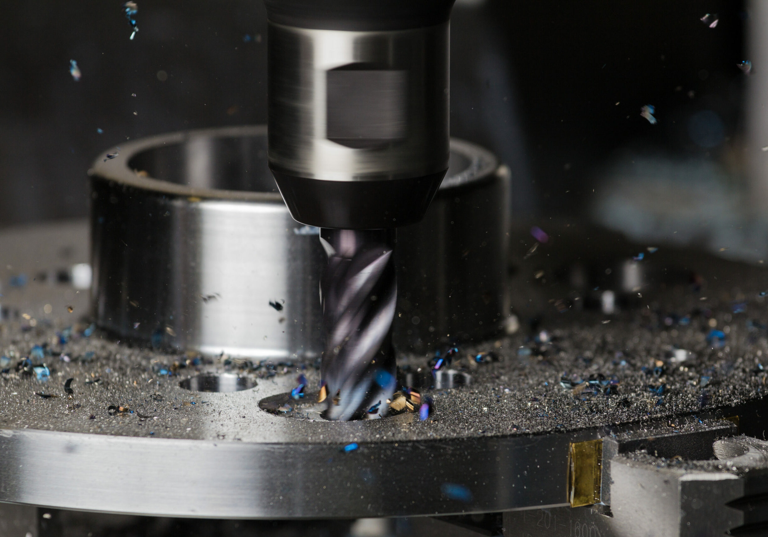 A hole is milled in a flange on a CNC machining center using a carbide endmill